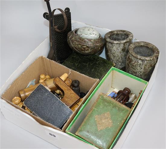 A box of assorted curios including a chess set and serpentine vases